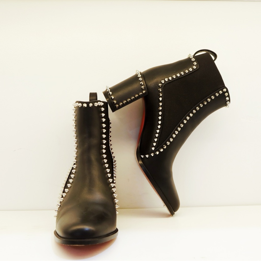 Christian Louboutin Out Line Spike Lug 100 leather heeled ankle boot in black.